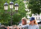 Girls feeding birds in Notre Dame Square