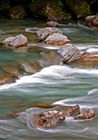 Rocks in the Haast River by Thunder Creek Falls